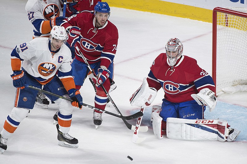 
              Montreal Canadiens goaltender Carey Price makes a save against New York Islanders' John Tavares (1) as Canadiens' Alexei Emelin (74) defends during the first period of an NHL hockey game Thursday, Feb. 23, 2017, in Montreal. (Graham Hughes/The Canadian Press via AP)
            