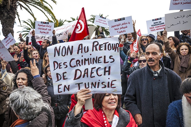 
              In this photo dated, Dec. 24, 2016, women demonstrate outside the Tunisian parliament, in Tunis, Saturday, Dec. 24, 2016. Poster reads : no to the return of Daesh's criminals in Tunisia. About 200 people have protested in the Tunisian capital against the return of Tunisian jihadis who have fought abroad. The gathering was prompted by the deadly truck attack in a Berlin Christmas market by Tunisian Anis Amri, who had pledged allegiance to the Islamic State group and was killed Friday in a police shootout. (AP Photo/Ons Abid)
            