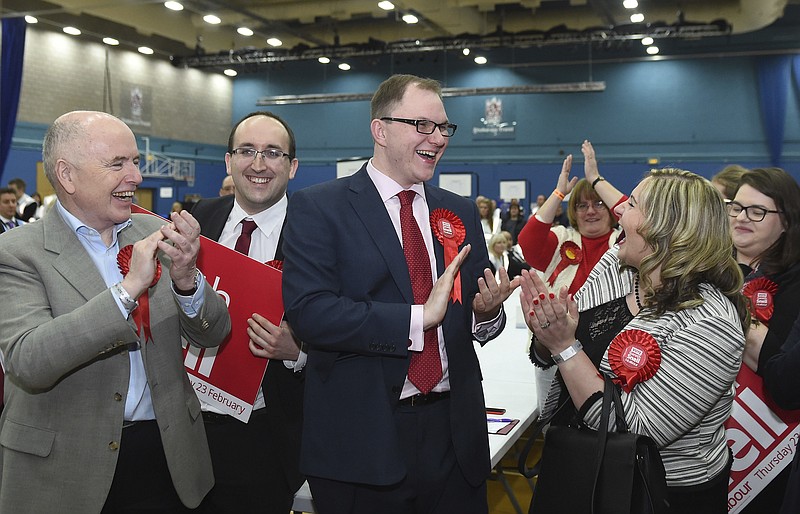 
              Labour candidate Gareth Snell, center right, celebrates with his wife Sophia, front right, after winning the Stoke-on-Trent Central by-election at Fenton Manor Sports Complex in Stoke, Britain Friday, Feb. 24, 2017. (Joe Giddens/PA via AP)
            
