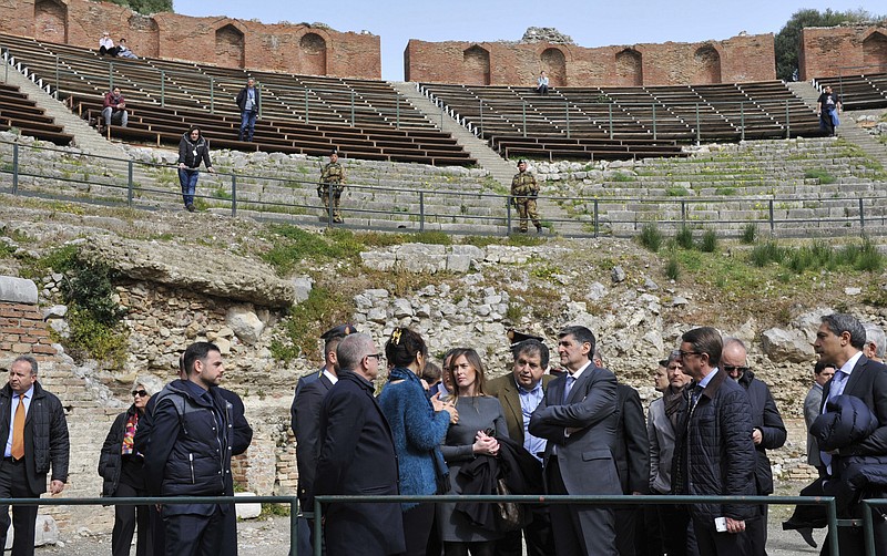 
              Italian Government Undersecretary Maria Elena Boschi, center, visits the ancient Greek theater of Taormina, Italy, the host town of the upcoming May 26-27 G-7 summit, Friday, Feb. 24, 2017. Italy still needs to build two helicopter landing pads and repave miles of road, but Boschi promised Friday that everything will be ready for the summit being held in the stunning Sicilian town overlooking the sea. (AP Photo/Salvatore Cavalli)
            