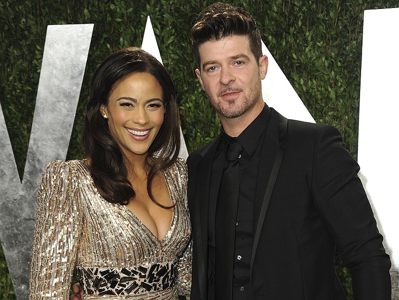 
              FILE - In this Feb. 24, 2013 file photo, Paula Patton and Robin Thicke arrive at the 2013 Vanity Fair Oscars Viewing and After Party at the Sunset Plaza Hotel in West Hollywood, Calif. In a Feb. 21, 2017, court filing, Patton's attorneys accused Thicke of evidence tampering by altering a court order in an attempt to get the actress arrested for kidnapping in an ongoing custody dispute between the former couple. The filing was released Thursday, Feb. 23, one day before a trial on allegations that Thicke abused her and their 6-year-old son is scheduled to begin in  Long Beach, Calif. (Photo by Jordan Strauss/Invision/AP, File)
            