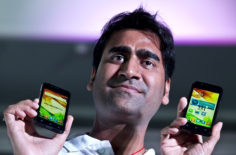 
              FILE - In this July 7, 2016 file photo, Mohit Goel, Director of Indian company Ringing Bells Pvt. Ltd. shows Freedom 251 smartphones at a press conference in New Delhi, India. Police say Mohit Goel was arrested late Thursday in the northern town of Ghaziabad following a complaint that his company, Ringing Bells, had not supplied the handsets that a phone distribution company had paid for. (AP Photo/Saurabh Das, File)
            