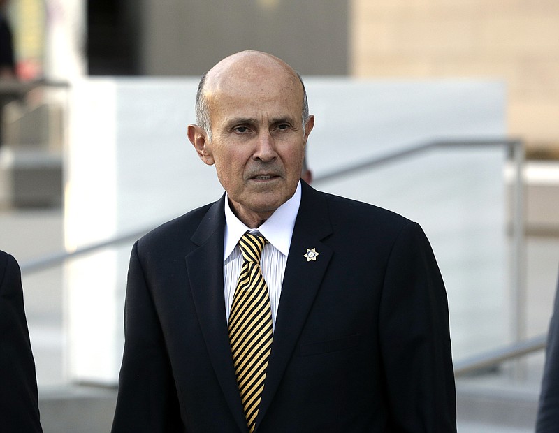 
              FILE - In this Dec. 19, 2016 file photo, former Los Angeles County Sheriff Lee Baca leaves federal court in Los Angeles. Baca went on trial on federal corruption charges Friday, Feb. 24, 2017, stripped of a ceremonial badge and unable to present a defense that might have won him sympathy if jurors knew he was in the early stage of Alzheimer's disease. Instead, his lawyer dropped only a hint of what he couldn't say as he attacked the obstruction of justice and lying charges as an outgrowth of a rookie FBI investigation riddled with blunders. (AP Photo/Nick Ut, File)
            