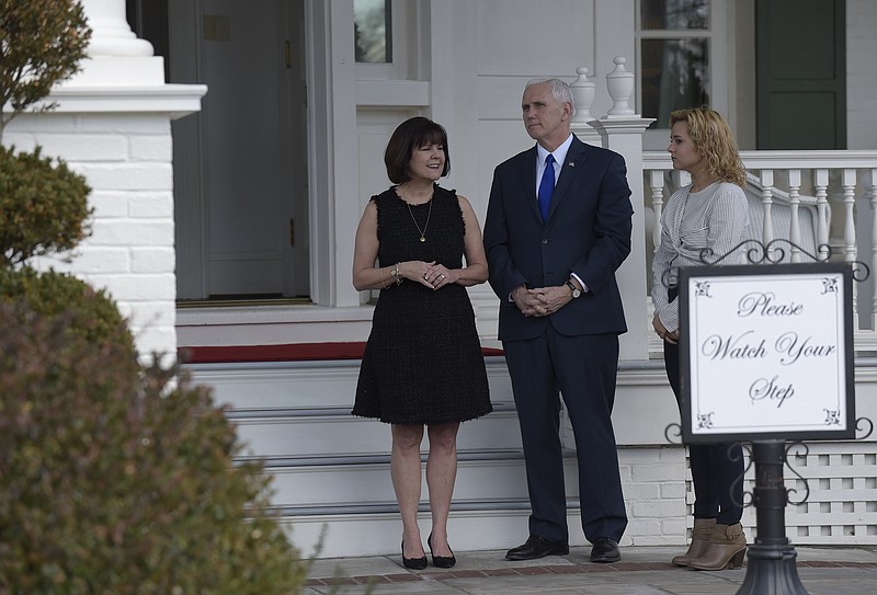 
              Vice President Mike Pence, his wife Karen Pence, left, and daughter Charlotte Pence, wait to greet governors to the Naval Observatory Washington, Friday, Feb. 24, 2017. (AP Photo/Susan Walsh)
            