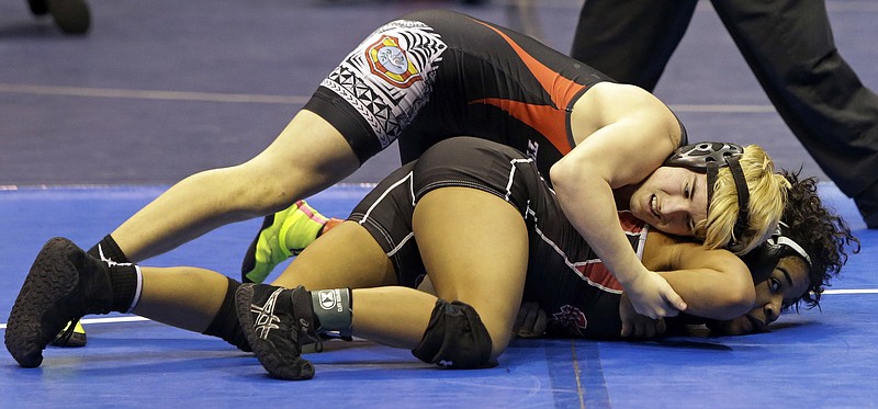 Mack Beggs, top, a transgender wrestler from Euless Trinity High School, competes in a quarterfinal match against Mya Engert, of Amarillo Tascosa, during the State Wrestling Tournament, Friday, Feb. 24, 2017, in Cypress, Texas. Beggs was born a girl and is transitioning to male but wrestles in the girls division. ( Melissa Phillip/Houston Chronicle via AP)