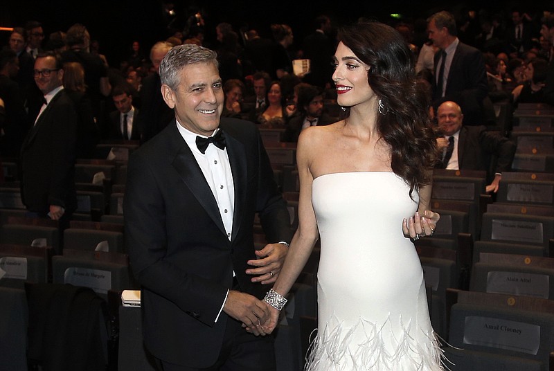 
              Actor George Clooney and Amal Clooney arrive at the 42nd Cesar Film Awards ceremony at Salle Pleyel in Paris, Friday, Feb. 24, 2017. This annual ceremony is presented by the French Academy of Cinema Arts and Techniques. (AP Photo/Thibault Camus)
            