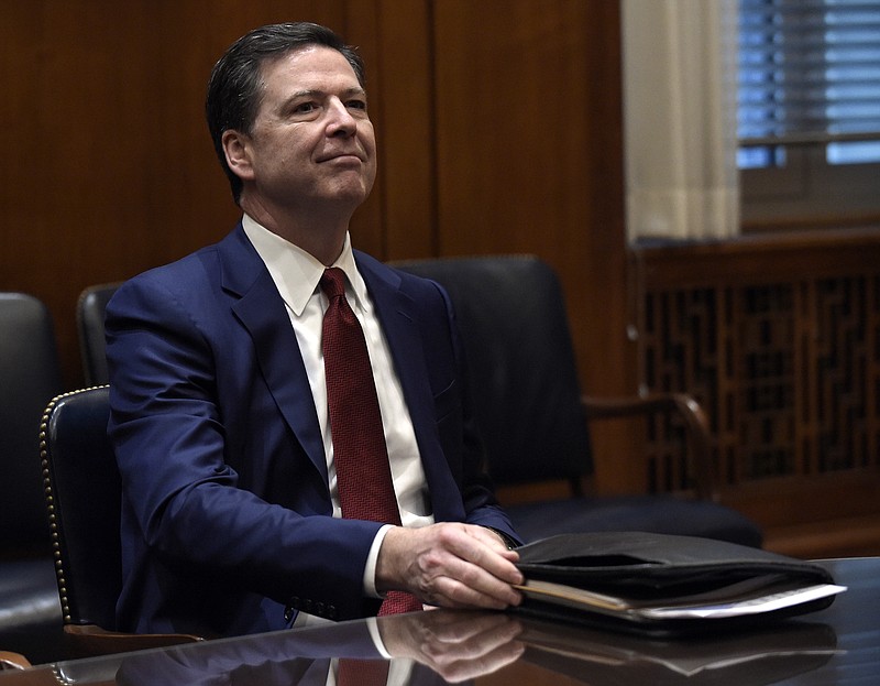 
              FILE - In this Feb. 9, 2017, file photo, FBI Director James Comey waits for the start of a meeting with Attorney General Jeff Session and the heads of federal law enforcement components at the Department of Justice in Washington. Comey is again in a familiar spot these days _ the middle of political tumult. As a high-ranking Justice Department official in the George W. Bush administration, he clashed with the White House over a secret surveillance program. Years later as head of the FBI, he incurred the ire of Hillary Clinton supporters for public statements on an investigation into her emails. Now, Comey is facing new political pressure as White House officials are encouraging him to follow their lead by publicly recounting private FBI conversations in an attempt to dispute reports about connections between the Trump administration and Russia. (AP Photo/Susan Walsh, Pool, File)
            