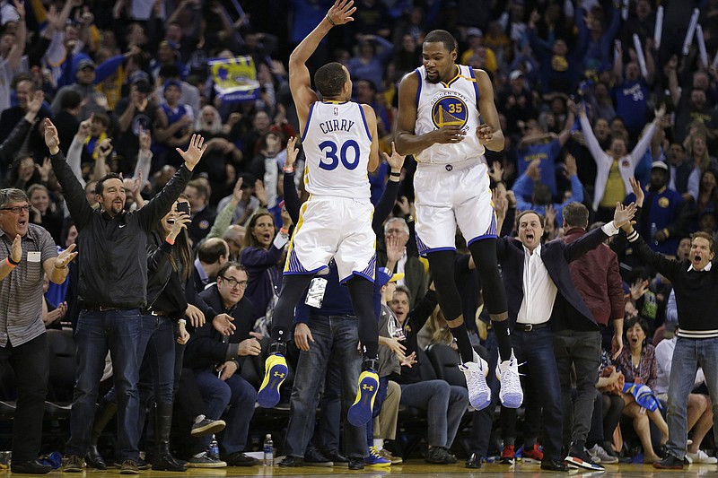 
              Golden State Warriors' Stephen Curry (30) and Kevin Durant (35) celebrate a score against the Los Angeles Clippers during the second half of an NBA basketball game Thursday, Feb. 23, 2017, in Oakland, Calif. (AP Photo/Ben Margot)
            