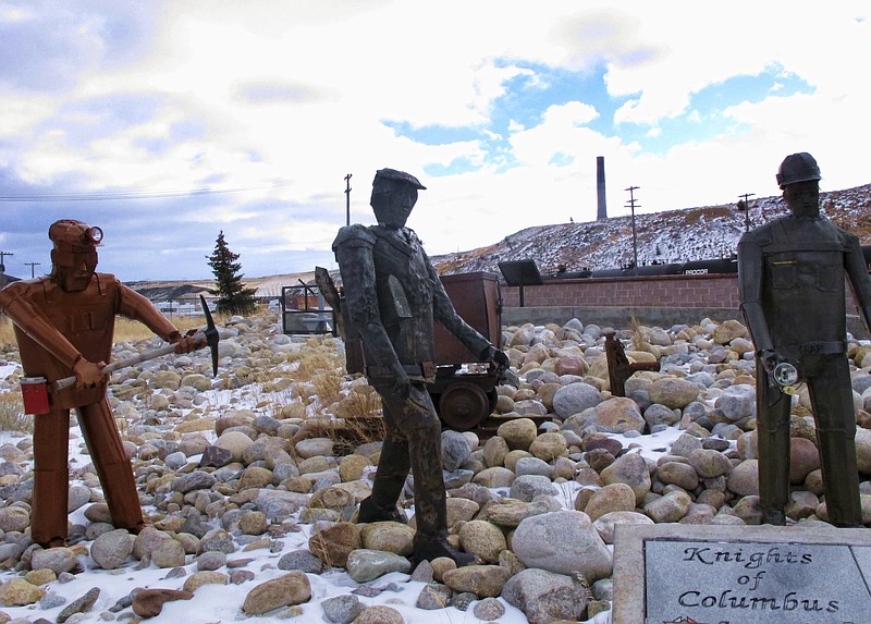 
              This Dec. 13, 2016 shows the former Anaconda smelter smokestack behind sculptures of miners at the Anaconda Smelter Stack State Park viewing area in Anaconda, Mont. Residents in the nearby community of Opportunity are suing for the right to clean the toxic metals left by the smelter from their yards and claim federal environmental officials and the smelter's owner have botched a 34-year cleanup. (AP Photo/Matt Volz)
            