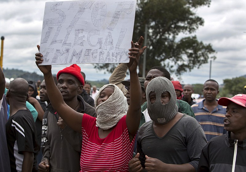 
              South Africans wave anti-immigration placards during a protest in Pretoria, South Africa, Friday, Feb. 24, 2017. Resentment against foreigners has sometimes turned deadly in South Africa amid accusations that they take jobs from locals in a country where unemployment is above 25 percent. Others are blamed for drug-dealing and other crimes. In 2015, anti-immigrant riots in and around the city of Durban killed at least six people. The Nelson Mandela Foundation in a statement criticized authorities for "giving permission for a march of hatred." (AP Photo/Yeshiel Panchia)
            