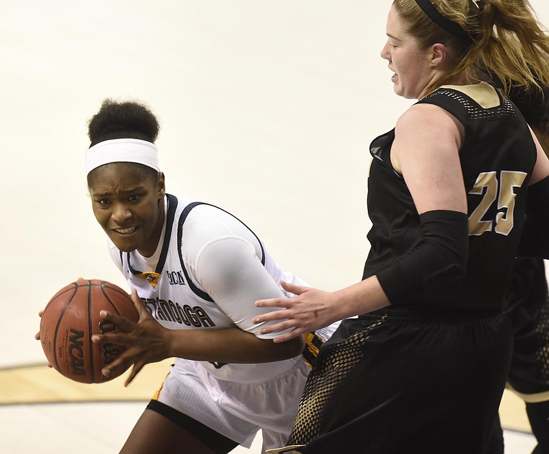 UTC's Aryanna Gilbert (35) looks for an open teammate while Wofford's Jamie Grob (25) defends.  The Wofford Terriers visited the Chattanooga Mocs in Southern Conference Basketball action at McKenzie Arena on February 25, 2017.