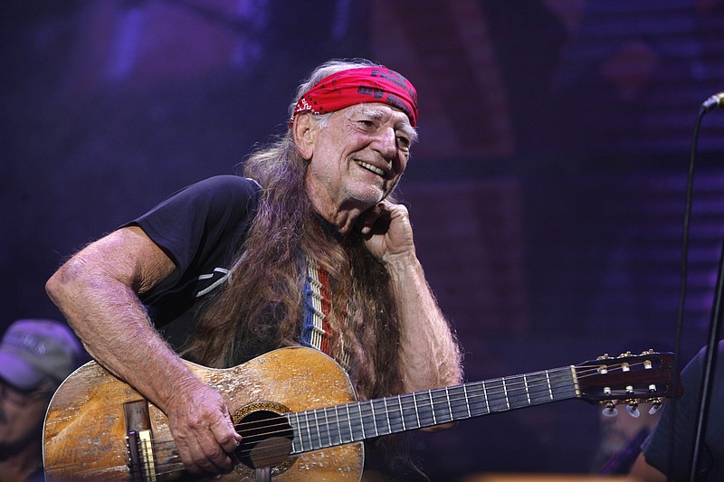 
              FILE - In this Sept. 9, 2007, file photo, Willie Nelson performs at Farm Aid on Randall's Island in New York.   Nelson, the children of the late reggae icon Bob Marley and comedian Whoopi Goldberg are just a few of the growing number of celebrities publicly jumping into the marijuana industry and eyeing the California pot market.  (AP Photo/Jason DeCrow, File)
            