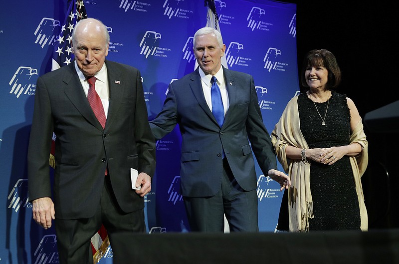 
              Vice President Mike Pence, center, takes the stage with his wife Karen Pence, right, after they were introduced by former Vice President Dick Cheney, left, at the Republican Jewish Coalition annual leadership meeting, Friday, Feb. 24, 2017, in Las Vegas. (AP Photo/John Locher)
            