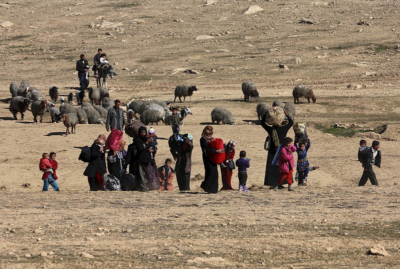 
              Displaced Iraqis flee their homes due to fighting between Iraqi special forces and Islamic State militants, on the western side of Mosul, Iraq, Saturday, Feb. 25. 2017. (AP Photo/ Khalid Mohammed)
            