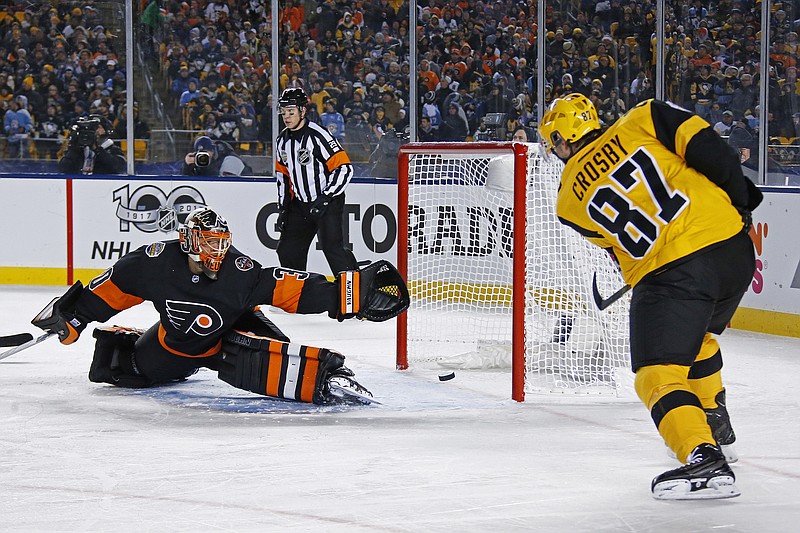 
              Pittsburgh Penguins' Sidney Crosby (87) gets a shot past Philadelphia Flyers' Michal Neuvirth (30) for a goal during the first period of an NHL Stadium Series hockey game at Heinz Field in Pittsburgh, Saturday, Feb. 25, 2017. (AP Photo/Gene J. Puskar)
            