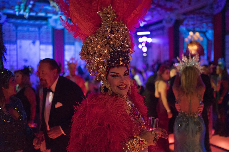 
              A guest in a costume poses for the photo as she enjoys a traditional Carnival ball at the Copacabana Palace hotel in Rio de Janeiro, Brazil, Saturday, Feb. 25, 2017. In stark contrast to the hundreds of hard-charging street parties across Rio that are open to anyone, the "Baile do Copa" bills itself as a fairytale event where the country's elite can see and be seen in a hotel known for both opulence and a lengthy tradition of welcoming world leaders and stars. (AP Photo/Leo Correa)
            