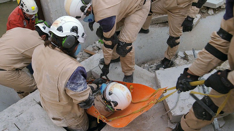 
              This image released by Netflix shows a scene from the documentary "White Helmets." The 40-minute Netflix documentary, is nominated for an Oscar for Best Documentary Short. A 21-year-old Syrian cinematographer Khaled Khateeb, one of three people credited for cinematography, has been blocked from traveling to Los Angeles for the Oscars.  (Netflix via AP)
            