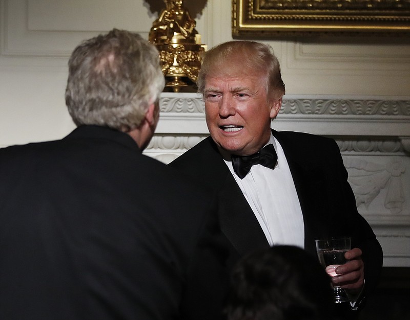 
              President Donald Trump shakes hands with National Governors Association Chair Virginia Gov. Terry McAuliffe, during a dinner reception for the annual National Governors Association winter meeting Sunday, Feb. 26, 2017, at the State Dining Room of the White House, in Washington. (AP Photo/Manuel Balce Ceneta)
            