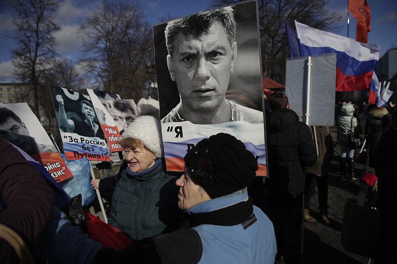 
              People gather together prior a march in memory of opposition leader Boris Nemtsov, who was killed two years ago, in Moscow, Russia, Sunday, Feb. 26, 2017. Several thousand people held a march in Moscow in memory of the Russian opposition leader to mark the second anniversary of his killing. (AP Photo/Pavel Golovkin)
            