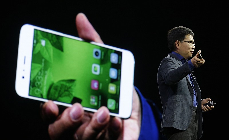 
              Chief executive officer of consumer devices division for Huawei Technologies Co. Richard Yu presents the new phone Huawei P10 Plus before the Mobile World Congress in Barcelona, Spain, Sunday, Feb. 26, 2017. The Mobile World Congress will be held 27 Feb. to 2 March. (AP Photo/Manu Fernandez)
            