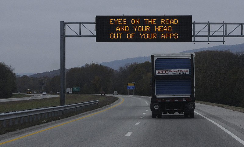 A TDOT information sign on the Bill Carter Causeway in Soddy-Daisy offers an instructional message for motorists who drive distracted.
