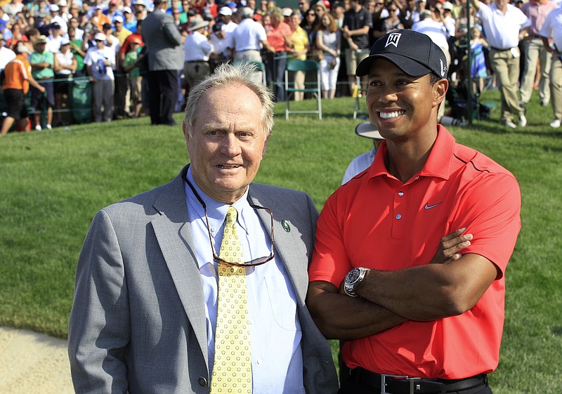 
              File-This June 3, 2012, file photo shows Jack Nicklaus, left, and Tiger Woods talking after Woods won the Memorial golf tournament at the Muirfield Village Golf Club in Dublin, Ohio.  Nicklaus says he was "painting a picture" when he suggested after a practice round with Tiger Woods at the 1996 Masters that Woods had the game to win at least 10 green jackets. He referred to Woods as a "puzzle" on Sunday, Feb. 26, 2017, at the Honda Classic. (AP Photo/Tony Dejak, File)
            