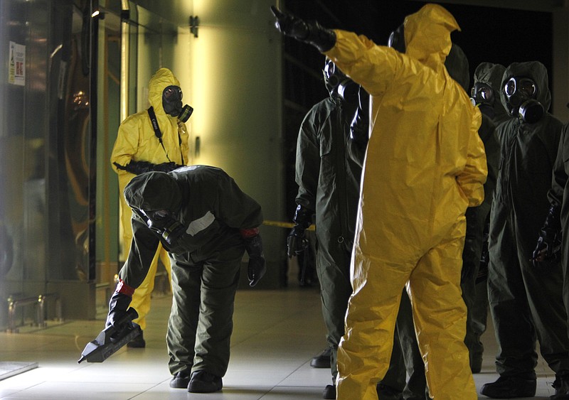 A hazmat crew scan the decontamination zone at Kuala Lumpur International Airport 2 in Sepang, Malaysia on Sunday, Feb. 26, 2017. Malaysian police ordered a sweep of Kuala Lumpur airport for toxic chemicals and other hazardous substances following the killing of Kim Jong Nam. (AP Photo/Daniel Chan)