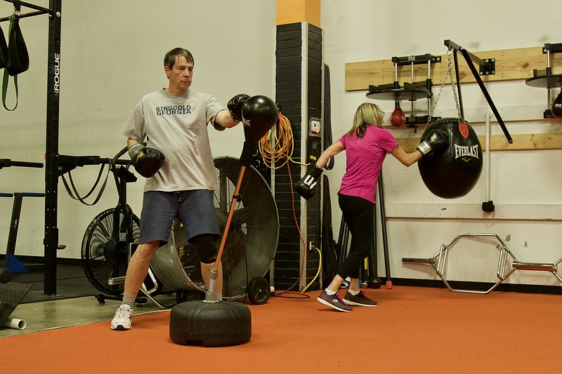 David Stackpole takes a swing at a reflex bag at Scenic City Boot Camp in a session for Rock Steady Boxing. Scenic City's classes have routinely seen around 10 people, and co-owner Dr. Kristen Harvey is hoping to get more as word about the program spreads.