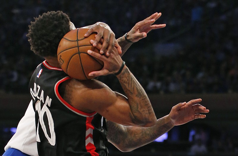 
              Toronto Raptors guard DeMar DeRozan (10) tries to hold onto the ball after New York Knicks center Kyle O'Quinn, left, (whose hands are visible at right) nearly knocked it from his hands, in the first half of an NBA basketball game at Madison Square Garden in New York, Monday, Feb. 27, 2017. (AP Photo/Kathy Willens)
            