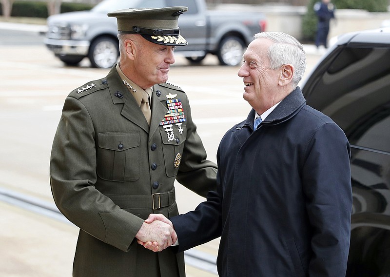 
              FILE - In this Jan. 21, 2107 file photo, Joint Chiefs Chairman Gen. Joseph Dunford greets Defense Secretary Jimn Mattis at the Pentagon. A new military strategy to meet President Donald Trump’s demand “to obliterate” the Islamic State group is likely to deepen U.S. military involvement in Syria, possibly with more ground troops, even as the current U.S. approach in Iraq appears to be working and will require fewer changes. Dunford said Feb. 23 that the strategy will take aim not just at the Islamic State but at al-Qaida and other extremist organizations in the Middle East and beyond whose goal is to attack the United States. He emphasized that it would not rest mainly on military might. (AP Photo/Alex Brandon, File)
            