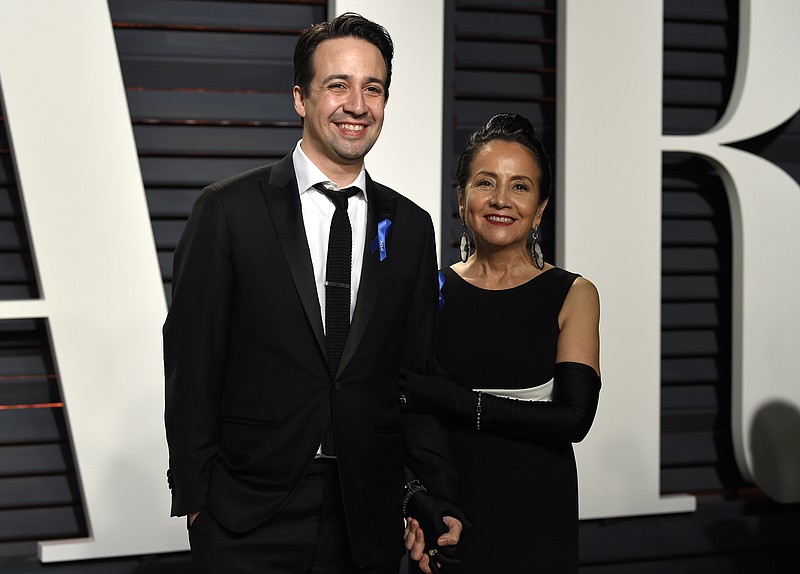 
              Lin-Manuel Miranda, left, and Luz Towns-Miranda arrive at the Vanity Fair Oscar Party on Sunday, Feb. 26, 2017, in Beverly Hills, Calif. (Photo by Evan Agostini/Invision/AP)
            