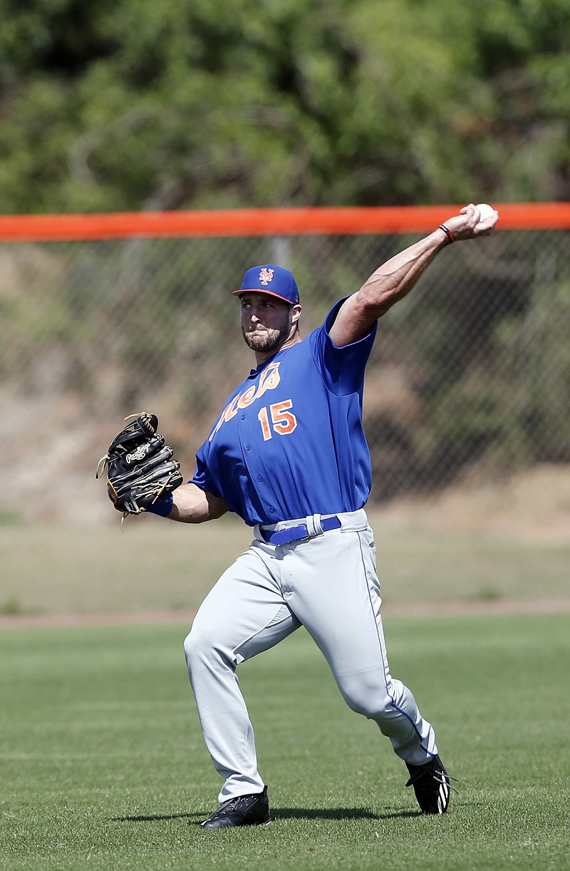 
              Former NFL quarterback and New York Mets outfielder Tim Tebow works during a spring training baseball practice Monday, Feb. 27, 2017, in Port St. Lucie, Fla. (AP Photo/John Bazemore)
            