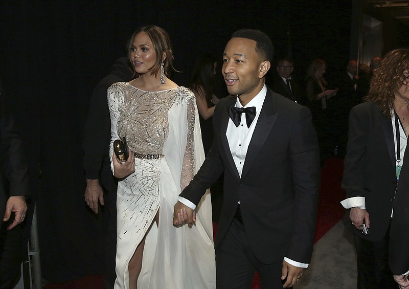 
              Chrissy Teigen, left, and John Legend appear backstage at the Oscars on Sunday, Feb. 26, 2017, at the Dolby Theatre in Los Angeles. (Photo by Matt Sayles/Invision/AP)
            