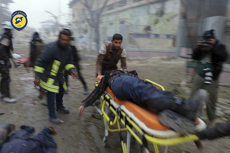 
              FILE -- In this Nov. 30, 2016 file photo provided by the Syrian Civil Defense White Helmets, which has been authenticated based on its contents and other AP reporting, shows Civil Defense workers carrying a victim on a stretcher after artillery fire struck the Jub al-Quba district in Aleppo, Syria. Politics continued to pervade the Academy Awards Sunday as the 40-minute Netflix documentary "The White Helmets" took the best documentary short award. The denial of entry into the U.S. for the film's 21-year-old Syrian cinematographer put "The White Helmets" in the broader spotlight. (Syrian Civil Defense White Helmets via AP, File)
            