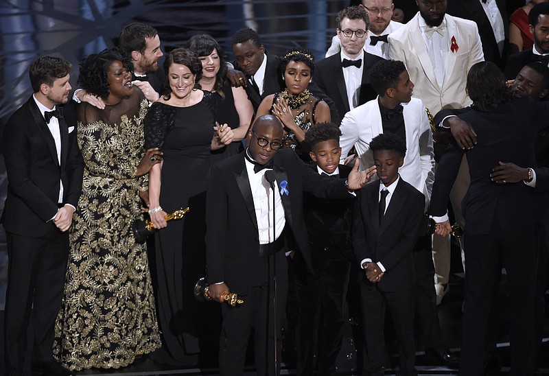 
              Barry Jenkins, foreground center, and the cast accept the award for best picture for "Moonlight" at the Oscars on Sunday, Feb. 26, 2017, at the Dolby Theatre in Los Angeles. (Photo by Chris Pizzello/Invision/AP)
            