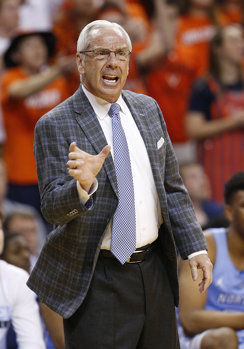 
              North Carolina head coach Roy Williams directs his team during the first half of an NCAA college basketball game against Virginia in Charlottesville, Va., Monday, Feb. 27, 2017. (AP Photo/Steve Helber)
            