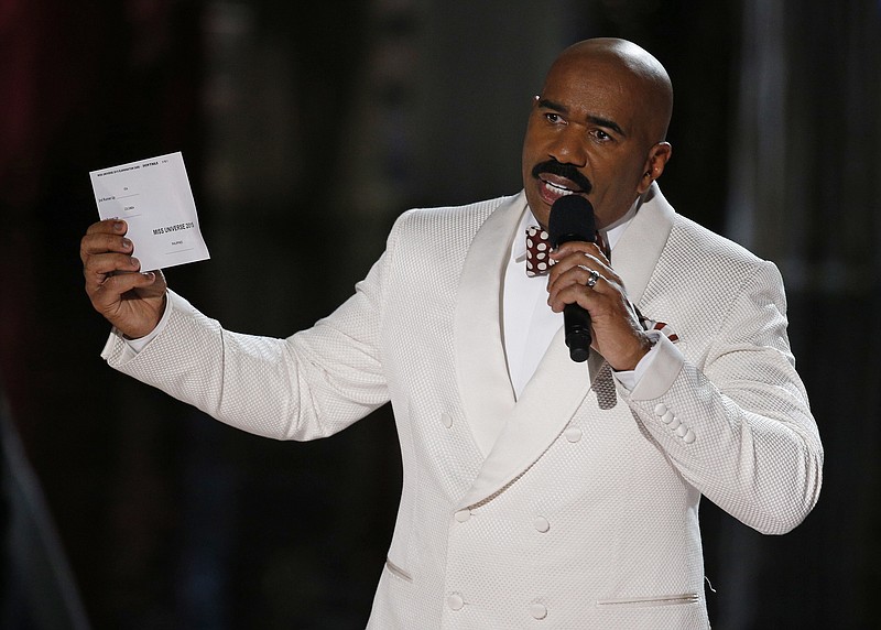 
              FILE - In this Dec. 20, 2015, file photo, Steve Harvey holds up the card showing the winners after he incorrectly announced Miss Colombia Ariadna Gutierrez at the winner at the Miss Universe pageant in Las Vegas. After an apparent envelope mix-up led Beatty and co-presenter Faye Dunaway to hand out the Oscars' best picture award to “La La Land” instead of the real winner, “Moonlight,” on Feb. 26, 2017, Harvey tweeted: “Call me Warren Beatty. I can help you get through this!” (AP Photo/John Locher, File)
            