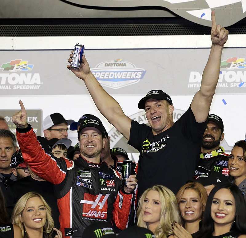 
              Kurt Busch, left, celebrates in Victory Lane with New England Patriots' Rob Gronkowski after winning the NASCAR Daytona 500 auto race at Daytona International Speedway in Daytona Beach, Fla., Sunday, Feb. 26, 2017. (AP Photo/Terry Renna)
            