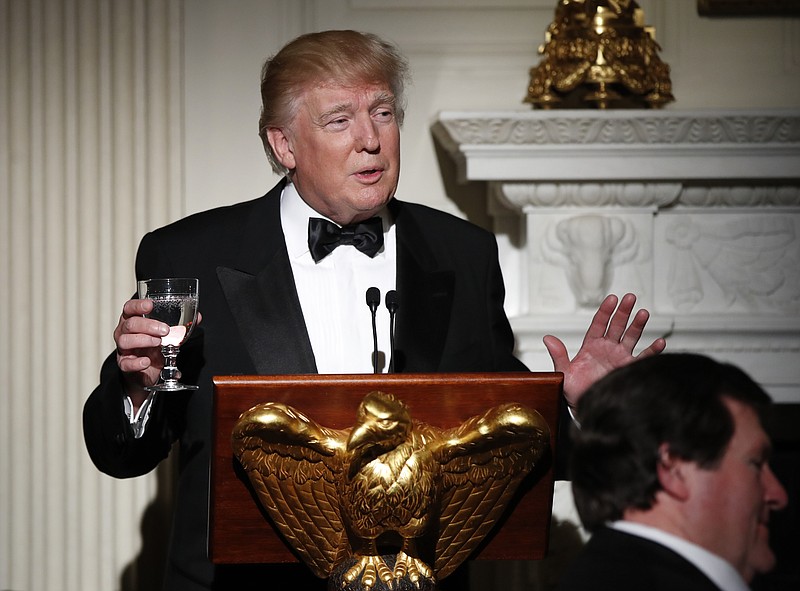 
              President Donald Trump makes a toast during a dinner reception for the annual National Governors Association winter meeting Sunday, Feb. 26, 2017, at the State Dining Room of the White House, in Washington. (AP Photo/Manuel Balce Ceneta)
            