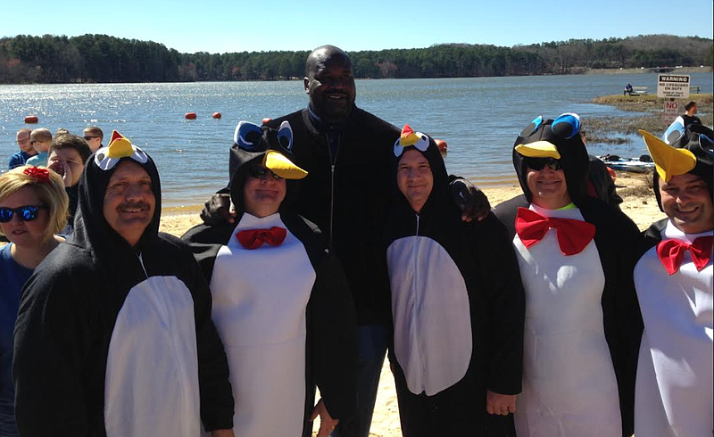 Officer Terry Smith, Assistant Chief Cliff Cason, Officer Bart Chandler, Captain Chris Crossen, and Sergeant Ricky Long post with Shaquille O'Neal at Saturday's Polar Plunge.