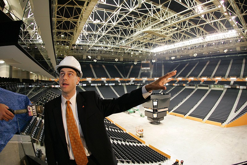 In this 2007 file photo, then-Tennessee Senior Associate Athletics Director John Currie leads a tour of the newly renovated Thompson-Boling Arena in Knoxville, Tenn. Tennessee spent $20 million on renovations which included replacing the arena's trademark-orange seats with black ones and hanging a new scoreboard.