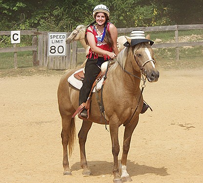 Calloway at 16 years old, riding Casey. A counselor-in-training at that point, it was her job to train young horses on how to be ridden by the younger campers.