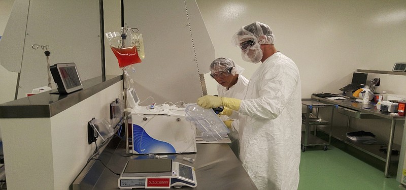 
              In this May 2016 photo provided by Kite Pharma, cell therapy specialists at the company's manufacturing facility in El Segundo, Calif., prepare blood cells from a patient to be engineered in the lab to fight cancer. The experimental gene therapy, called CAR-T cell, turns a patient's own blood cells into specialized cancer killers and worked in the study, with more than one third of very sick lymphoma patients showing no sign of disease six months after a single treatment, its maker said Tuesday, Feb. 28, 2017. (Kite Pharma via AP)
            