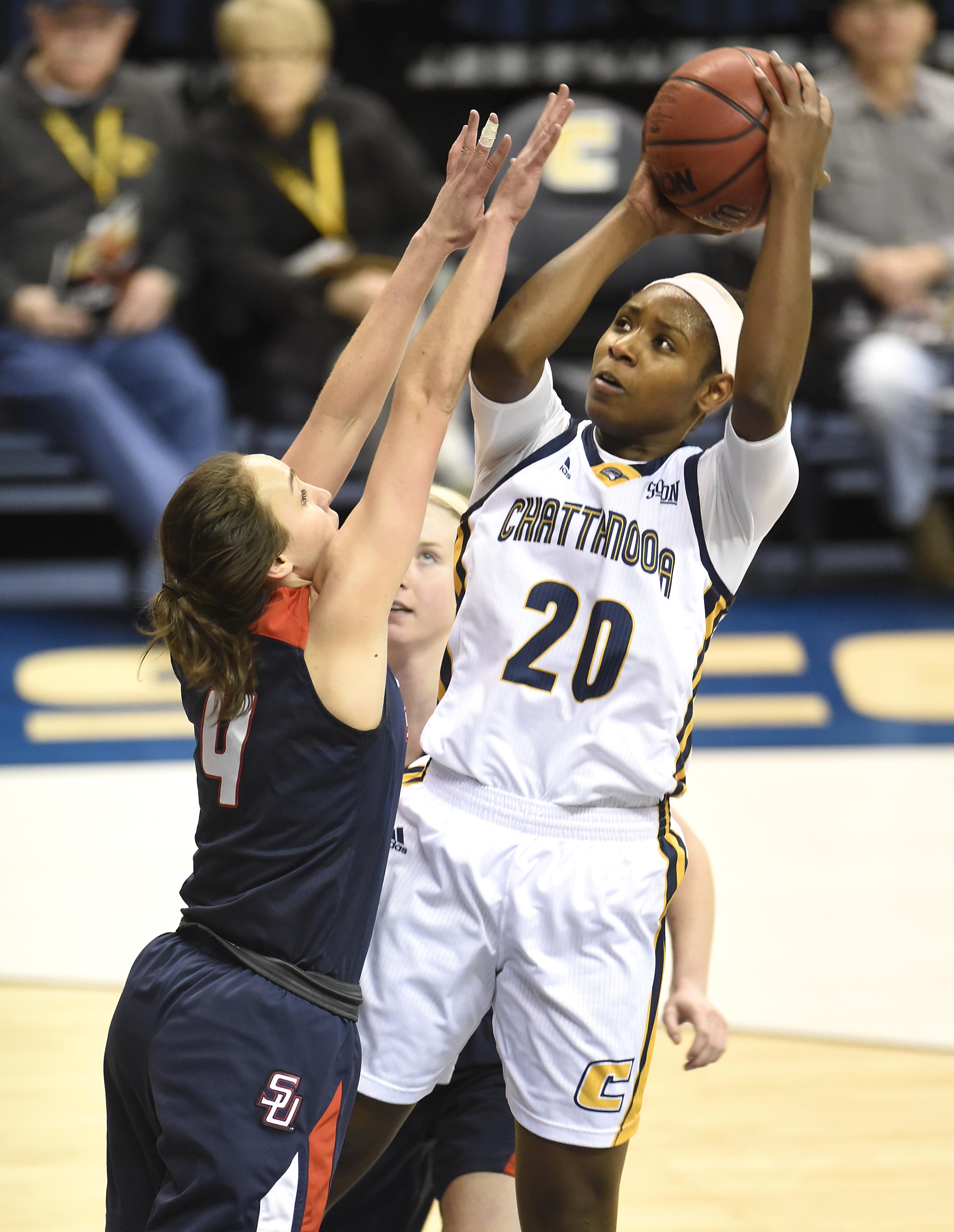 UTC's Keiana Gilbert (20) shoots from the paint while Samford's Lydia McGee (4) defends. The Samford Bulldogs visited the UTC Mocs in Southern Conference women's basketball action at McKenzie Arena on February 4, 2017.