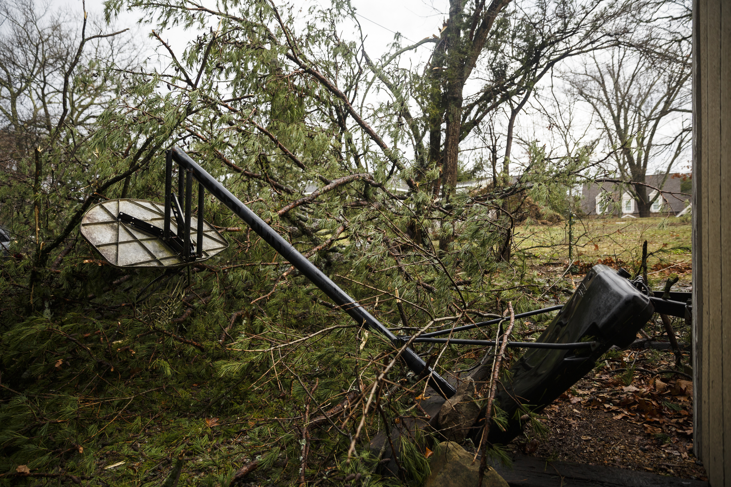 A tree fell on a basketball goal in an alley between Westwood Avenue and Highland Drive on Wednesday, March 1, 2017, in Chattanooga, Tenn. Severe storms swept through the region Wednesday afternoon.