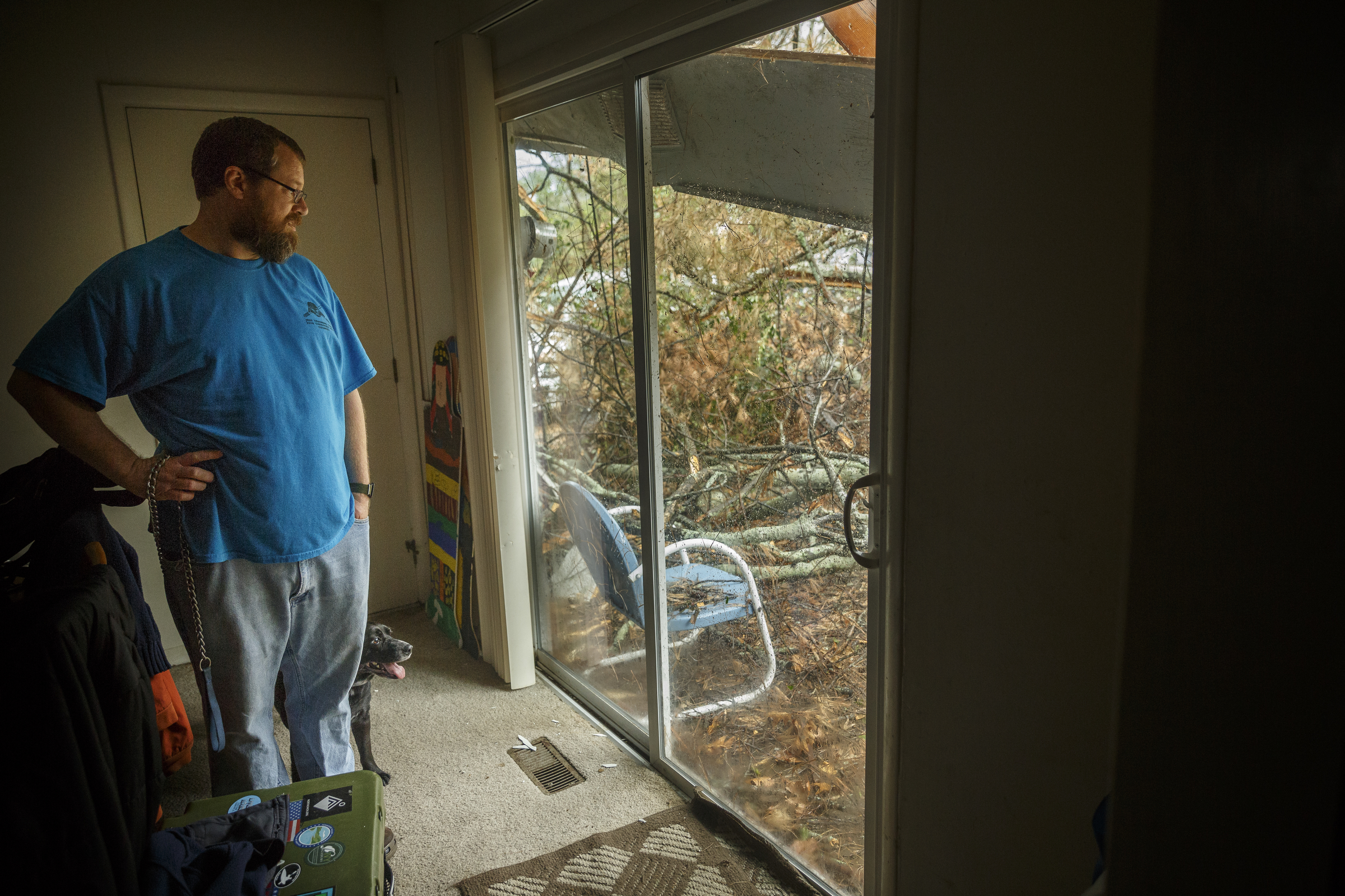 Darrell Meece looks out at storm debris in his back yard after a tree fell on his home on Highland Drive on Wednesday, March 1, 2017, in Chattanooga, Tenn. Severe storms swept through the region Wednesday afternoon.