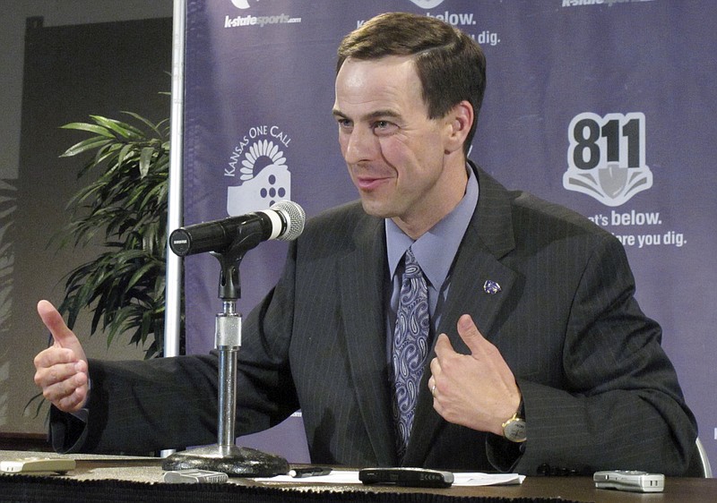 In this June 16, 2010, file photo, Kansas State athletic director John Currie answers reporters' questions about the future of the Big 12 in Manhattan, Kan. Tennessee announced Tuesday, Feb. 28, 2017, that they hired Currie from Kansas State to replace Dave Hart as the Volunteers' athletic director. (AP Photo/John Hanna, File)