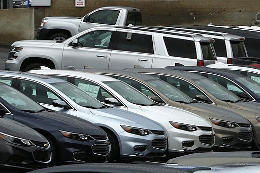 In this Thursday, Jan. 12, 2017, photo, Chevrolet cars sit on the lot of a dealer in Pittsburgh. Strong demand for pickups and SUVs helped brighten February 2017 for the U.S. auto industry. Overall sales of new vehicles were expected to fall slightly from last February as automakers cut back on deliveries to rental-car companies and other fleets. (AP Photo/Gene J. Puskar)