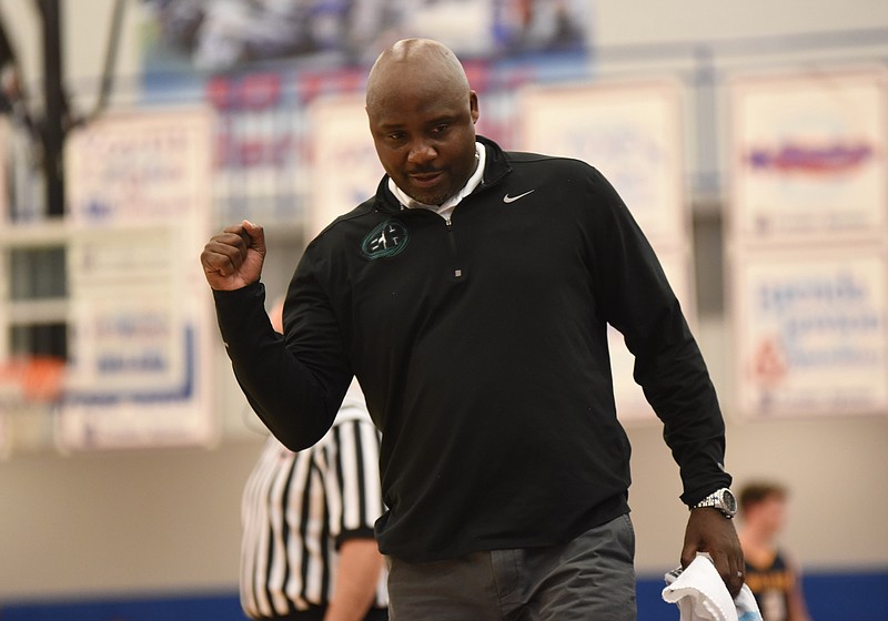 East Hamilton coach Rodney English pumps his fist after his team takes a lead over Walker Valley in the 63-57 win for the 3-AAA boys basketball championship.