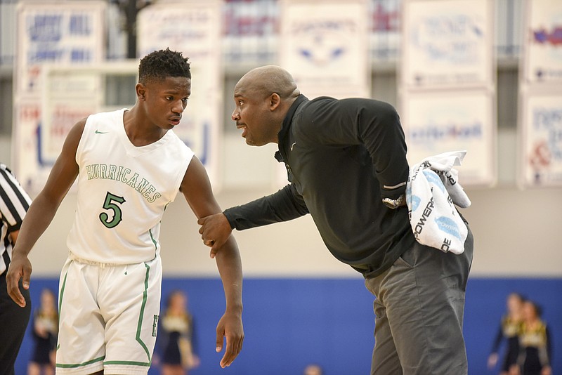 East Hamilton coach Rodney English pulls Sam Randolph closer for a word during the win over Walker Valley Thursday night at Cleveland. The Hurricanes won 63-57 for the 3-AAA boys' basketball championship.